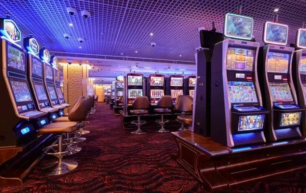 Macro view of a luxury slot machine screen showing bright symbols, fluid motion, and impressive visual effects